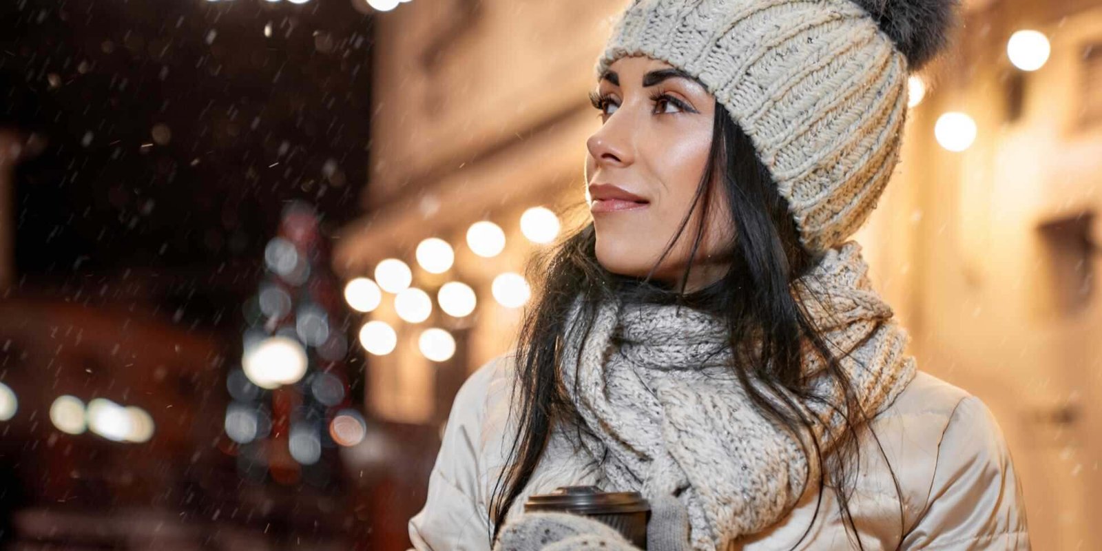 Winter Weather - Model in winter clothing with coffee cup posing.
