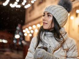 Winter Weather - Model in winter clothing with coffee cup posing.