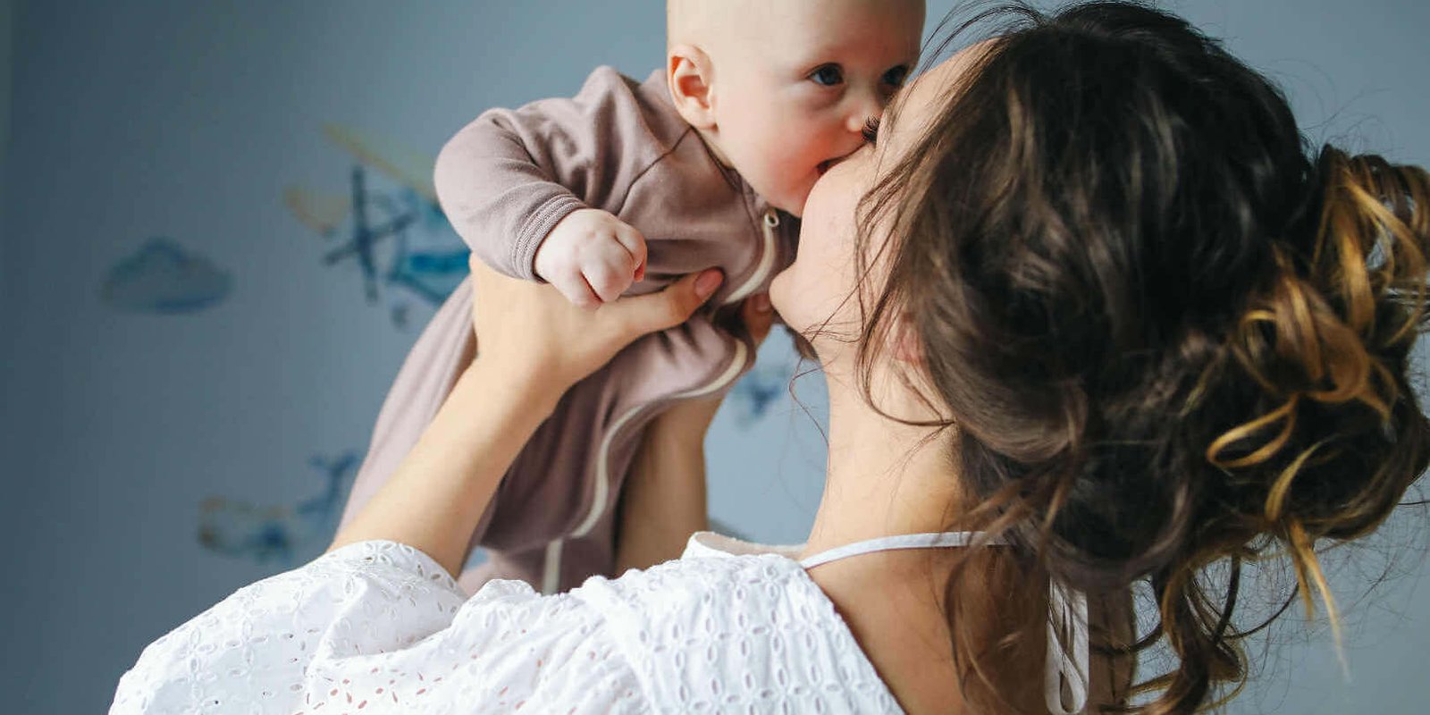 New Mom holding Baby up in her arms
